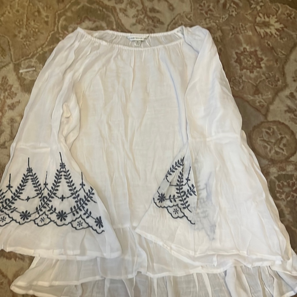White sheer long sleeve top can be used as a bikini cover-up.